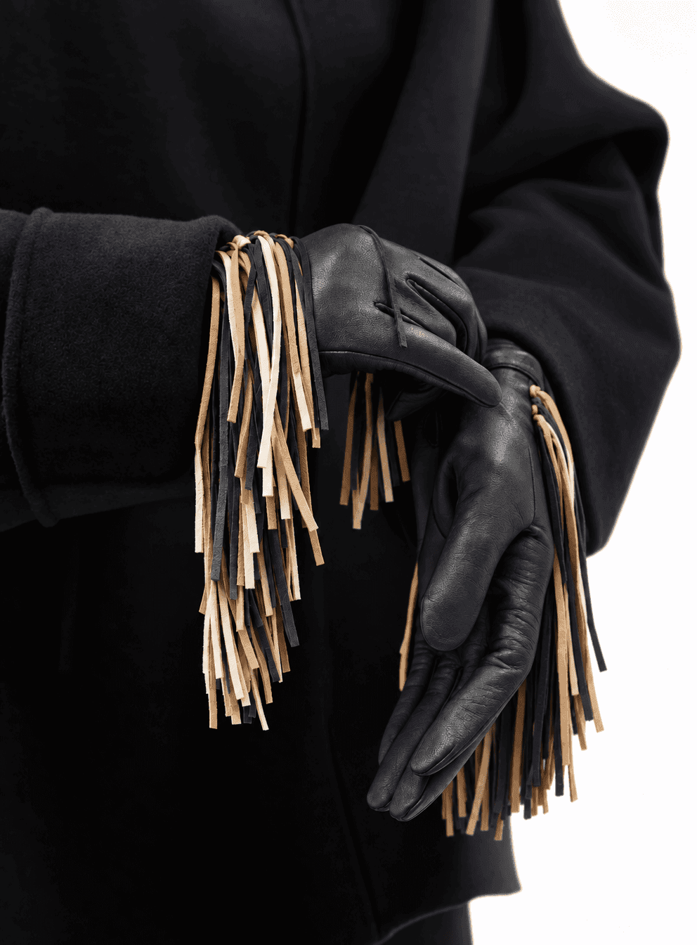 black nappa leather gloves with a long black, tan and cream fringe, worn with a black wool coat